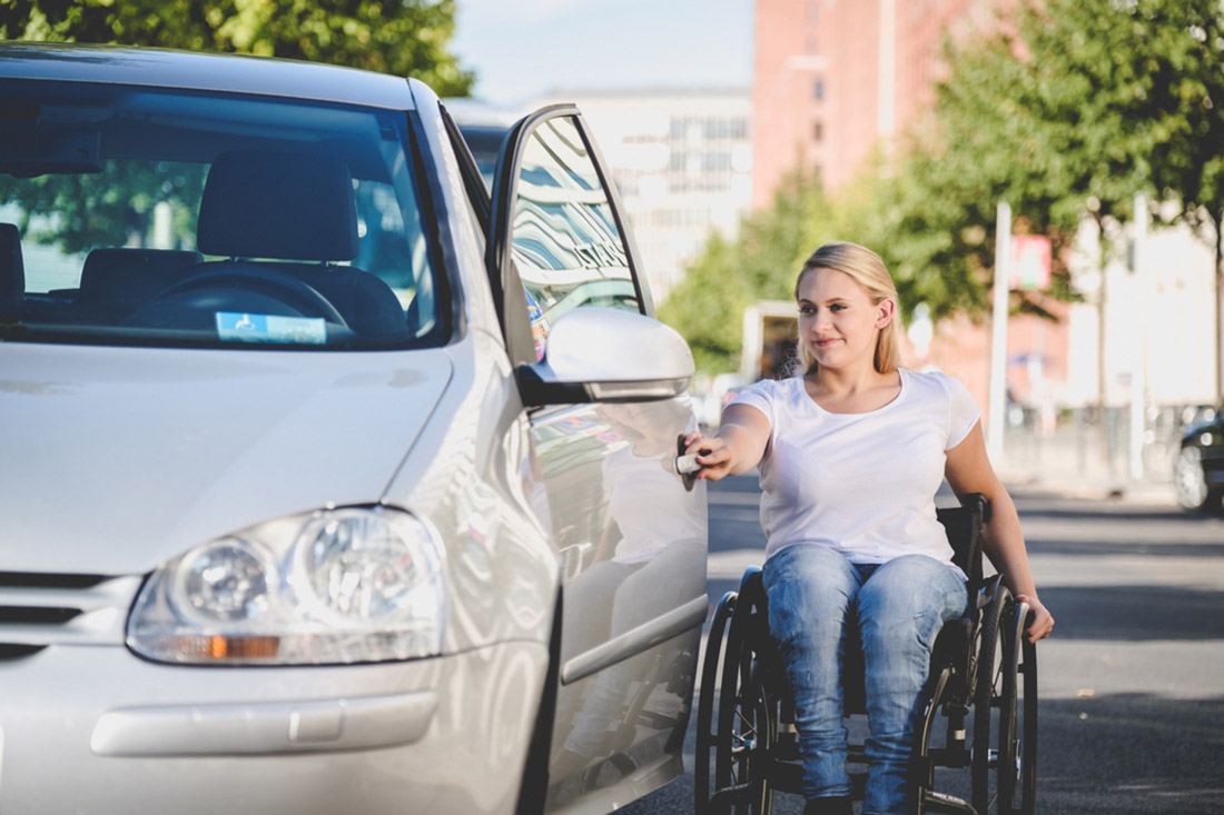 junge Frau mit Rollstuhl öffnet Autotüre, © visitBerlin, Bildnachweis: Andi Weiland